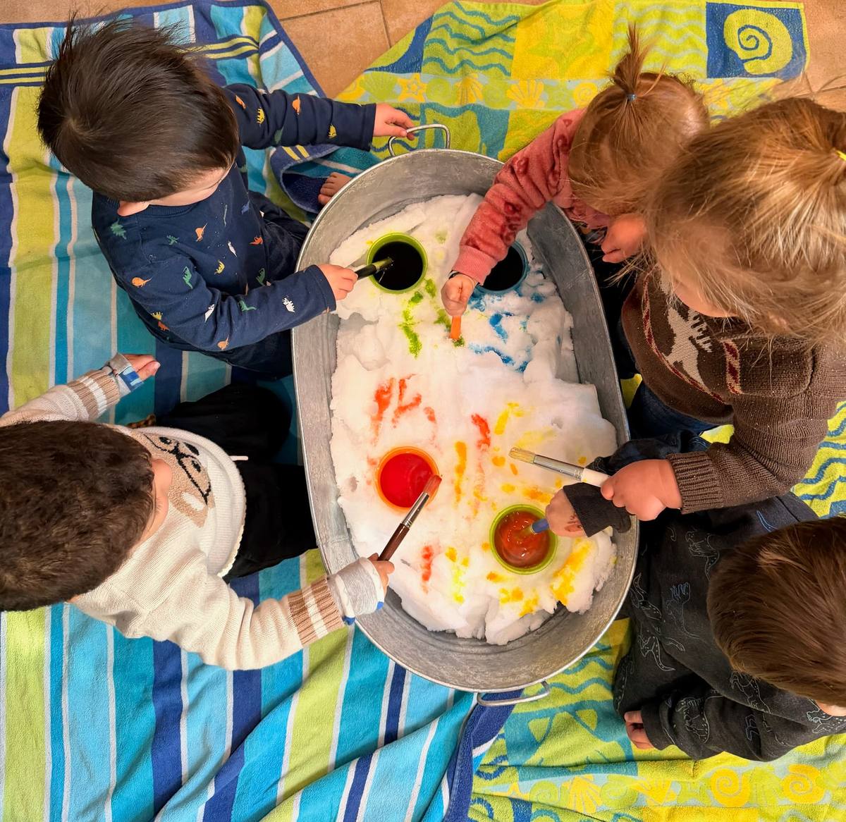 Children painting in colored snow